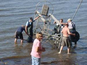 (From center clockwise) Kathy Cain, Dave Pearson, Bob Cain, David Gillette, Bernie Schuneman and Tom Grady taking the boat lift out of the water at the end of the summer season on Lake Koshkonong, Fort Atkinson, Wisconsin.